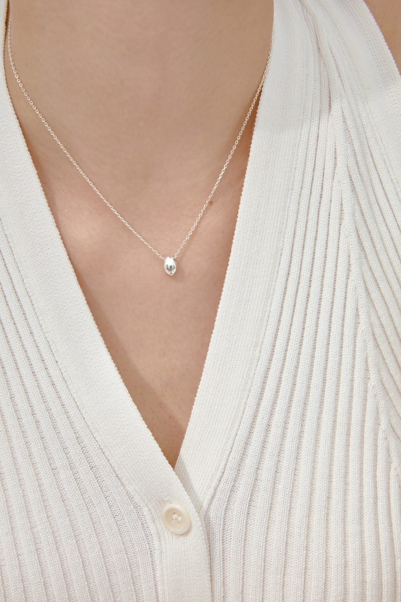 Silver teardrop necklace on model